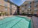 View of a crystal blue swimming pool and lounge chairs at 4221 W Spruce St # 2302, Tampa, FL 33607