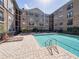 The pool has a clear blue swimming area with lounge chairs around it at 4221 W Spruce St # 2302, Tampa, FL 33607