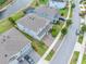 An aerial view showcases a manicured lawn, complemented by a landscaped walkway leading to a picturesque lakeside view at 4633 Ballantrae Blvd, Land O Lakes, FL 34638