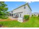Wide view of the backyard with a patio, green grass, home generator, and more at 4633 Ballantrae Blvd, Land O Lakes, FL 34638