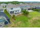 Aerial view of the home showcasing the lush green lawn, patio with seating, and screened-in pool at 4633 Ballantrae Blvd, Land O Lakes, FL 34638
