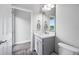 A well-lit bathroom with a gray vanity, marble countertop, and modern fixtures at 4633 Ballantrae Blvd, Land O Lakes, FL 34638