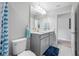 Bathroom featuring double sink vanity with gray cabinets and a walk-in shower at 4633 Ballantrae Blvd, Land O Lakes, FL 34638