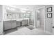A bright bathroom features double vanity, tiled floors, and glass-door shower at 4633 Ballantrae Blvd, Land O Lakes, FL 34638