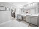 Bright bathroom featuring double vanity with modern fixtures and an open walk-in closet for storage at 4633 Ballantrae Blvd, Land O Lakes, FL 34638