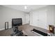 Bedroom features a ceiling fan, gray carpet, and workout equipment at 4633 Ballantrae Blvd, Land O Lakes, FL 34638