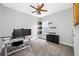Simple bedroom featuring neutral paint, a ceiling fan, and a modern workspace at 4633 Ballantrae Blvd, Land O Lakes, FL 34638