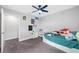 Bedroom features a ceiling fan, closet with shelving and bright natural light at 4633 Ballantrae Blvd, Land O Lakes, FL 34638