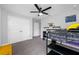 A gray bedroom with carpet featuring a loft bed, desk, shelving, and a closet at 4633 Ballantrae Blvd, Land O Lakes, FL 34638