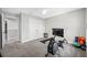 Bedroom features a ceiling fan, gray carpet, and workout equipment at 4633 Ballantrae Blvd, Land O Lakes, FL 34638