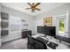 Bedroom features a ceiling fan, built-in wall shelves and gray carpet flooring at 4633 Ballantrae Blvd, Land O Lakes, FL 34638