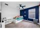 Bedroom featuring a blue accent wall, ceiling fan, and window at 4633 Ballantrae Blvd, Land O Lakes, FL 34638