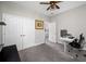 Bedroom with gray carpet, white walls, ceiling fan and a desk with computer at 4633 Ballantrae Blvd, Land O Lakes, FL 34638