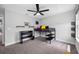 This bedroom features a ceiling fan, desk with shelves, and a black frame loft bed with gray carpet at 4633 Ballantrae Blvd, Land O Lakes, FL 34638