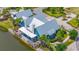 Aerial view of the clubhouse, lake, covered patio, and lush landscaping at 4633 Ballantrae Blvd, Land O Lakes, FL 34638