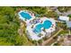 Stunning aerial view of the community pools, featuring multiple pools, a splash pad, and ample lounging space at 4633 Ballantrae Blvd, Land O Lakes, FL 34638