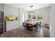 Cozy dining area with modern light fixture, wooden table, and backyard views at 4633 Ballantrae Blvd, Land O Lakes, FL 34638