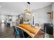 Contemporary dining room boasts a rustic wooden table and stylish pendant lighting at 4633 Ballantrae Blvd, Land O Lakes, FL 34638