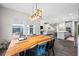 Bright dining area showcasing a wooden table, pendant lighting, and an open floor plan at 4633 Ballantrae Blvd, Land O Lakes, FL 34638