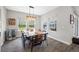 Charming dining room with a unique wooden table, seating, and views of the backyard pool at 4633 Ballantrae Blvd, Land O Lakes, FL 34638