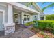 Inviting front porch with decorative plants and a welcome sign, leading to a beautiful home at 4633 Ballantrae Blvd, Land O Lakes, FL 34638