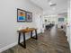 Hallway with wood-look tile flooring leading to living areas and kitchen at 4633 Ballantrae Blvd, Land O Lakes, FL 34638