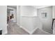Hallway with gray carpet, white walls, and window to the exterior at 4633 Ballantrae Blvd, Land O Lakes, FL 34638