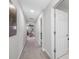 Neutral painted hallway with carpet leading to various rooms in the home at 4633 Ballantrae Blvd, Land O Lakes, FL 34638