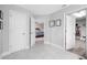 Neutral hallway leads to bedroom and closets with tile flooring and white doors at 4633 Ballantrae Blvd, Land O Lakes, FL 34638