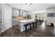 Modern kitchen boasts an island with bar seating, stainless steel appliances, and elegant pendant lighting at 4633 Ballantrae Blvd, Land O Lakes, FL 34638