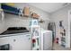 Laundry room featuring a front-load washer and dryer with storage shelves at 4633 Ballantrae Blvd, Land O Lakes, FL 34638