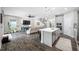 Open concept kitchen and living space with modern lighting, stainless appliances, and hardwood flooring at 4633 Ballantrae Blvd, Land O Lakes, FL 34638