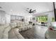 Expansive living room with a large sofa and seamless access to the outdoor patio at 4633 Ballantrae Blvd, Land O Lakes, FL 34638