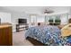 The main bedroom features a ceiling fan, sitting area, and neutral decor at 4633 Ballantrae Blvd, Land O Lakes, FL 34638