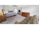 The main bedroom features a ceiling fan, sitting area, and warm wood furnishings at 4633 Ballantrae Blvd, Land O Lakes, FL 34638