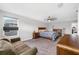 Spacious main bedroom with a ceiling fan, sitting area, and carpeted floor at 4633 Ballantrae Blvd, Land O Lakes, FL 34638