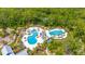 Aerial view of the community pool with tropical landscaping and plenty of lounge seating at 4633 Ballantrae Blvd, Land O Lakes, FL 34638
