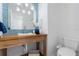 Bathroom vanity with wood drawers, stylish faucet, and modern mirror with bright lighting at 4706 Fox Hunt Dr, Tampa, FL 33624