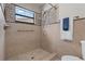 Bathroom shower features tiled walls, grab bars, and shower head at 4706 Fox Hunt Dr, Tampa, FL 33624
