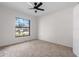 Bedroom with neutral carpet and ceiling fan and a large window providing natural light at 4706 Fox Hunt Dr, Tampa, FL 33624