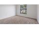 Bedroom with neutral carpet, and a large window providing natural light at 4706 Fox Hunt Dr, Tampa, FL 33624