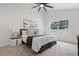Bright bedroom features a large window, a ceiling fan and neutral décor at 4706 Fox Hunt Dr, Tampa, FL 33624