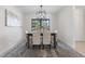 Elegant dining room featuring modern lighting, neutral decor, and comfortable seating for four at 4706 Fox Hunt Dr, Tampa, FL 33624