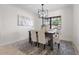 Elegant dining room featuring modern lighting, neutral decor, and comfortable seating for four at 4706 Fox Hunt Dr, Tampa, FL 33624