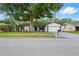 Charming single-story home featuring a well-maintained lawn, mature tree, and a two-car garage at 4706 Fox Hunt Dr, Tampa, FL 33624