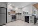 Bright eat-in kitchen with stainless steel appliances and breakfast bar offers modern comfort and style at 4706 Fox Hunt Dr, Tampa, FL 33624