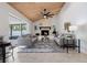 Bright living room with vaulted wood ceiling, fireplace, and sliding glass doors to the pool area at 4706 Fox Hunt Dr, Tampa, FL 33624