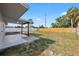 Spacious backyard featuring a covered patio and a wooden fence at 4803 Sierra Madre Dr, Tampa, FL 33634
