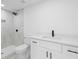 Bathroom featuring white walls, shower, vanity and sink with black fixtures at 4803 Sierra Madre Dr, Tampa, FL 33634