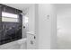 Modern bathroom featuring a dark marble tiled shower and sleek fixtures at 4803 Sierra Madre Dr, Tampa, FL 33634